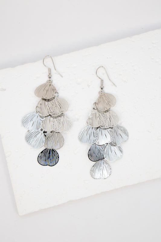 Pair of layered tassel earrings on a white surface