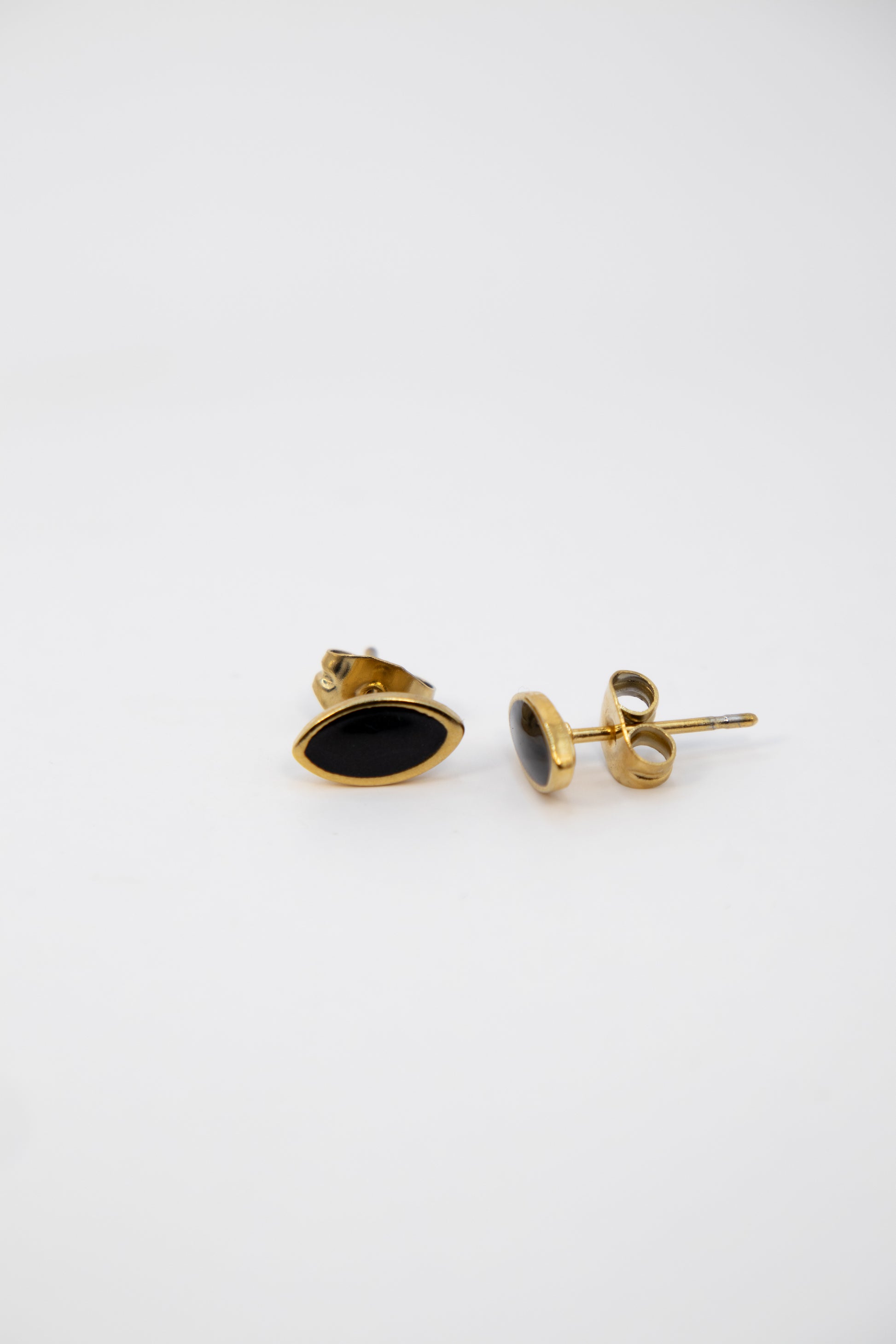 Gold and black earrings on a white background