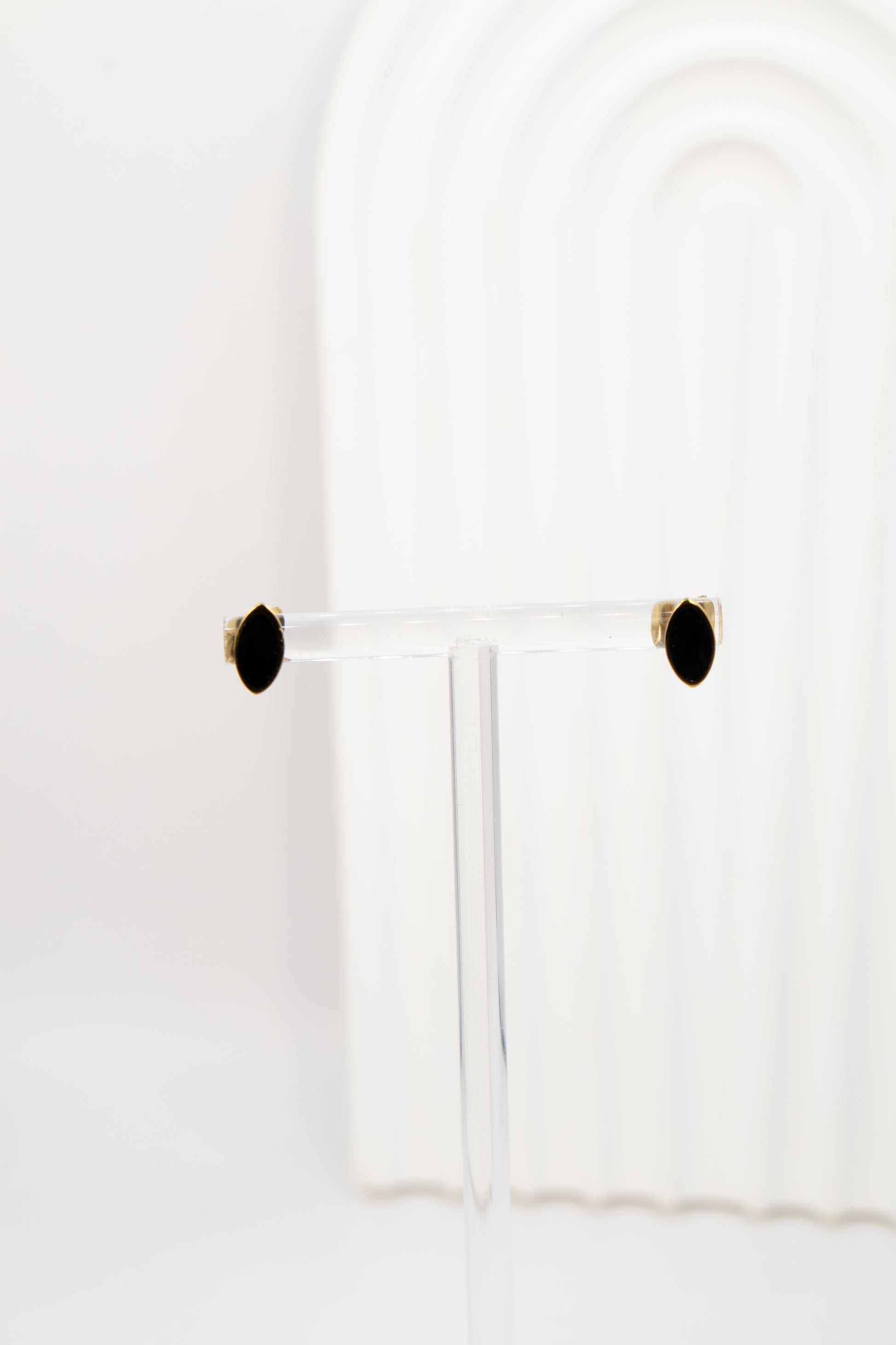 Gold earring studs with black centre shaped like a eye