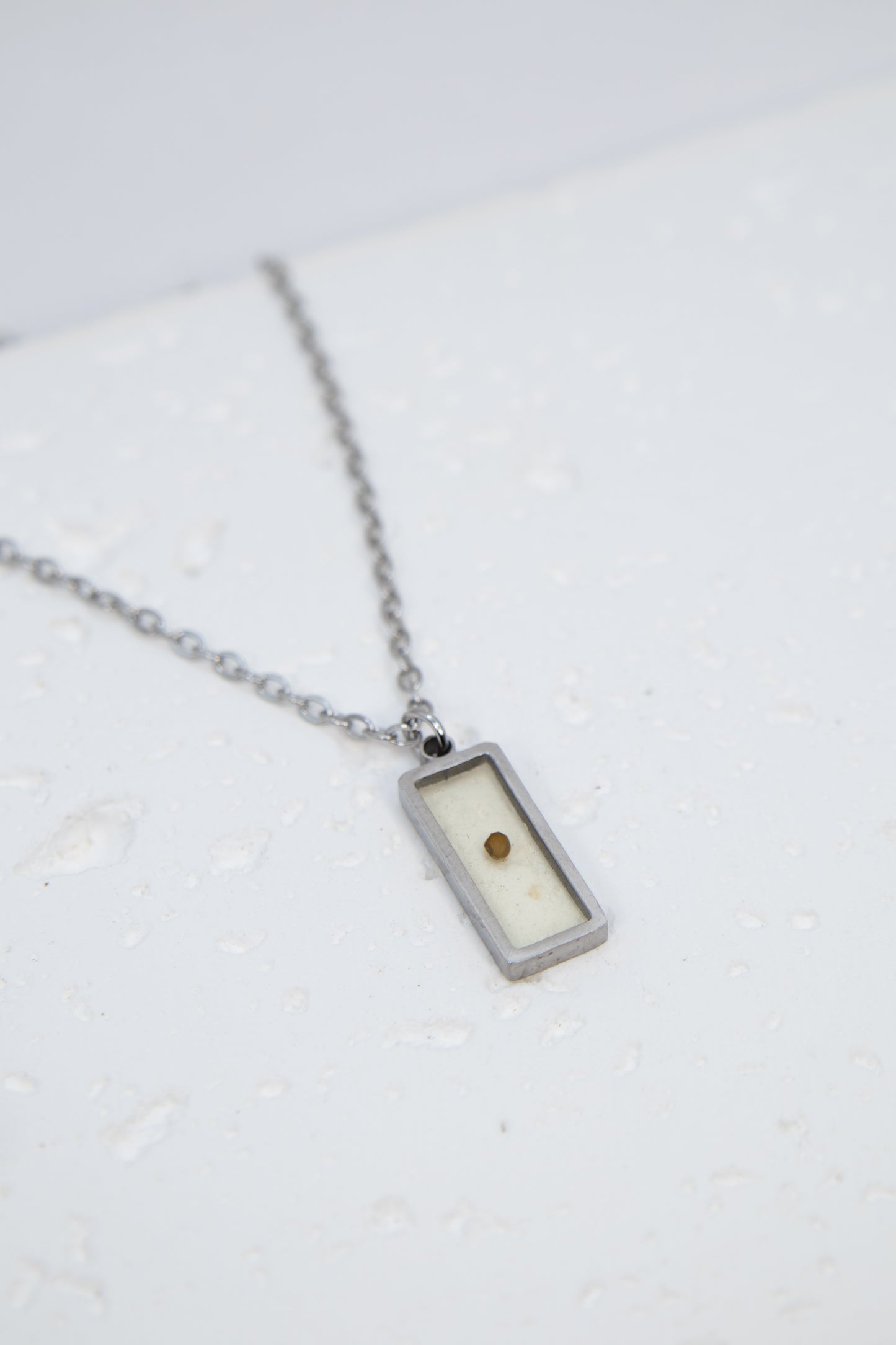 Necklace with a rectangular pendant on a white background