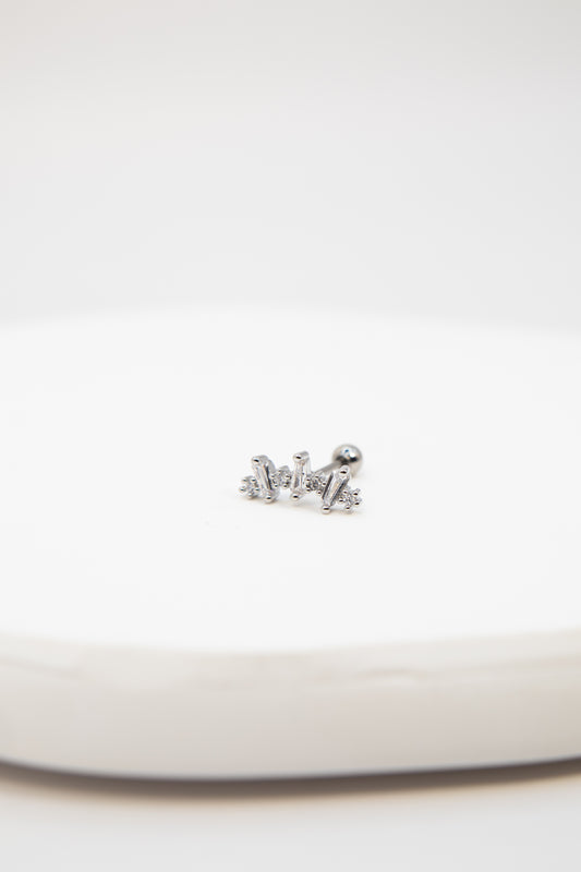 Silver crown-shaped earring on a white background