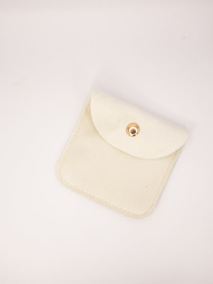 Beige fabric pouch with a gold clasp on a white background