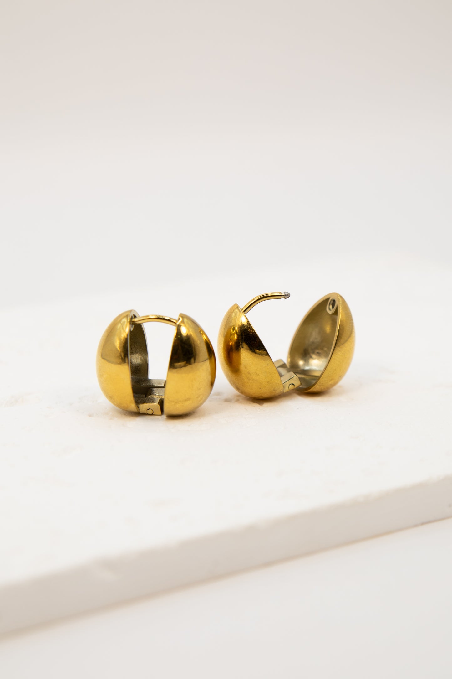 Gold hoop earrings on a white background