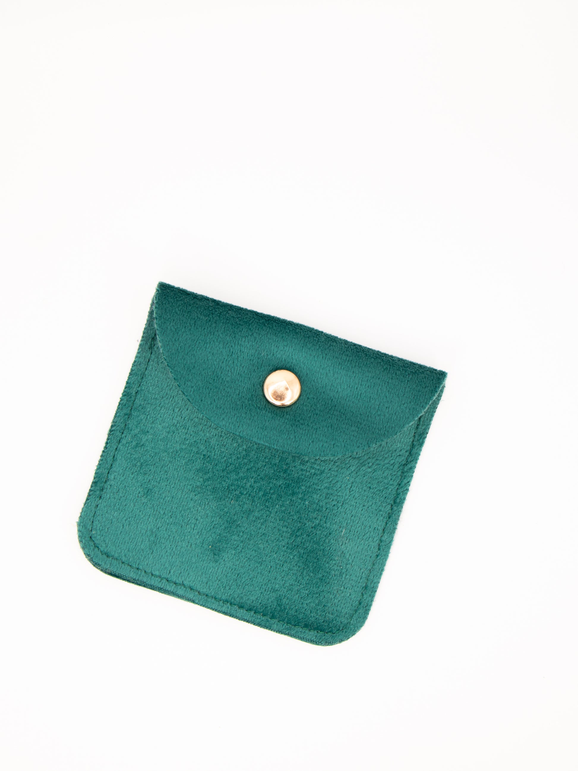 Green velvet pouch with a gold button on a white background