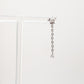 Silver chain earring with crystals on a white background