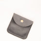 Small gray leather pouch with a gold clasp on a white background