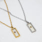 Two necklaces with rectangular pendants on a white surface