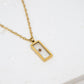 Gold necklace with a rectangular pendant on a white background