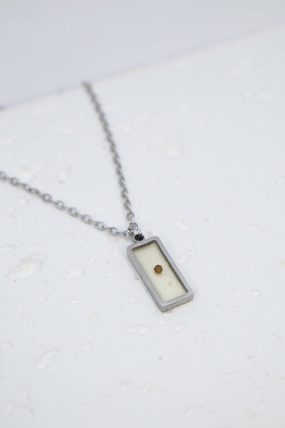 Necklace with a rectangular pendant on a white background