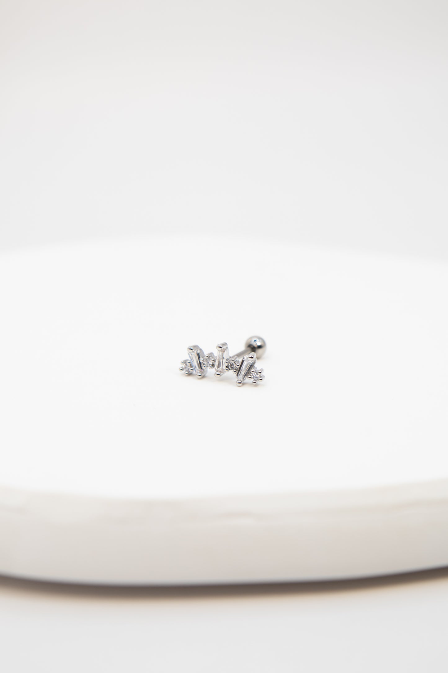 Silver earring on a white background
