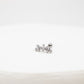 Silver crown-shaped earring on a white background
