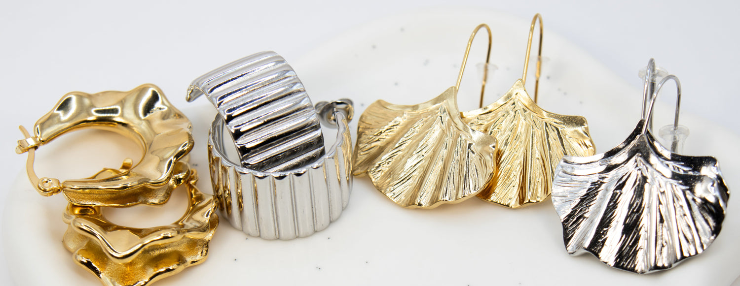 Set of gold and silver earrings on a white background