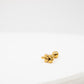 Gold earring with leaf design on a white background